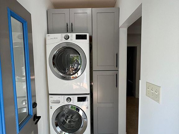 When you walk through the back door you enter into a small mudroom area with washer and dryer.