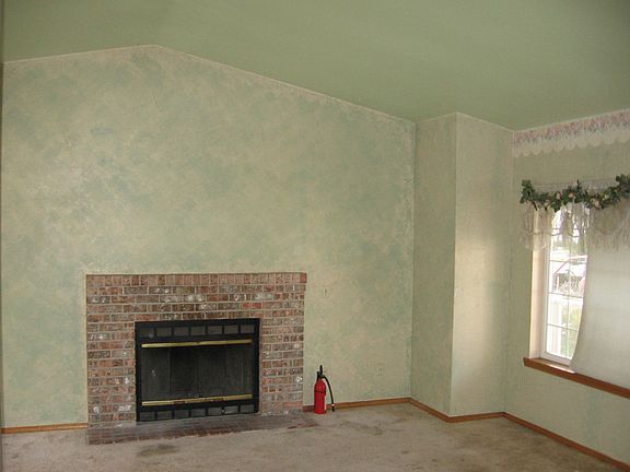 Living room with vaulted ceilings and wood burning fireplace