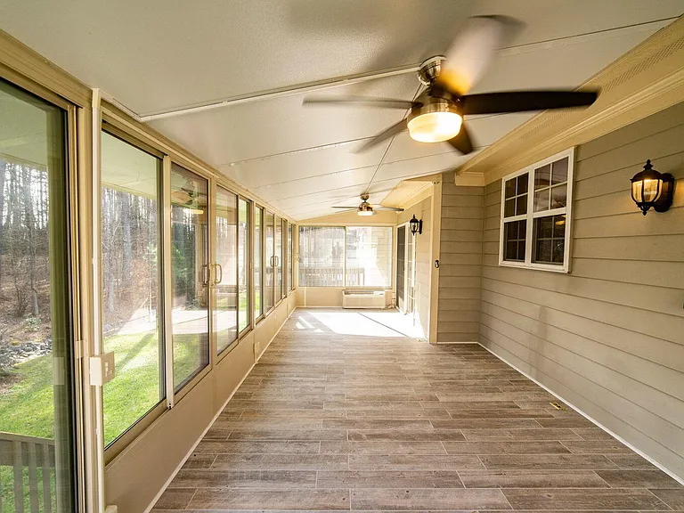 FOUR-SEASON SUNROOM WITH CEILING FANS AND HEATING AND COOLING UNIT