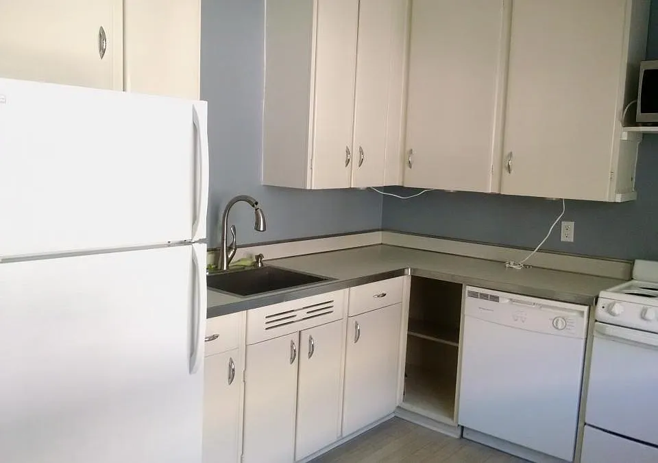 Very bright itchen, includes plenty of storage with restored period cabinets and handles, a dishwasher, and garbage disposal.