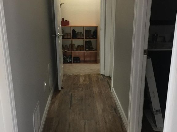 Hallway from key locked entry at stairs. bathroom door on right, laundry/utility on left.