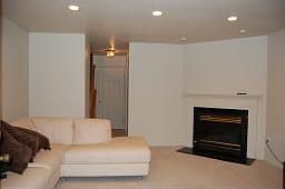 Cozy family room with fireplace with walk-out door leading to patio 