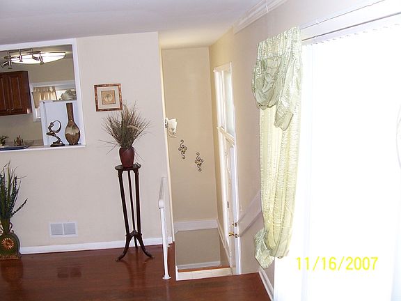View from LR facing bar overlooking kitchen. Facing stairs leading to front dr
