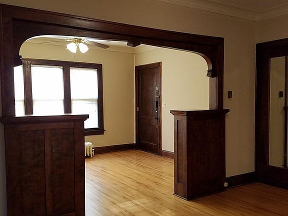 View from dining room. Front door & LR with ceiling fan. Hardwood floors.