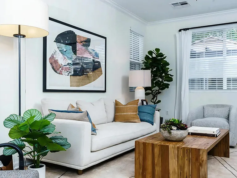 Sunlit Living Room with Large Windows and Modern Furnishings