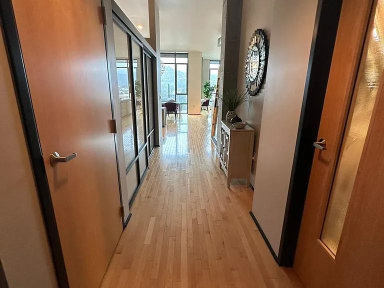 Hall entry, guest bath is on the right utility room is on the left with a coat closet and strorage.