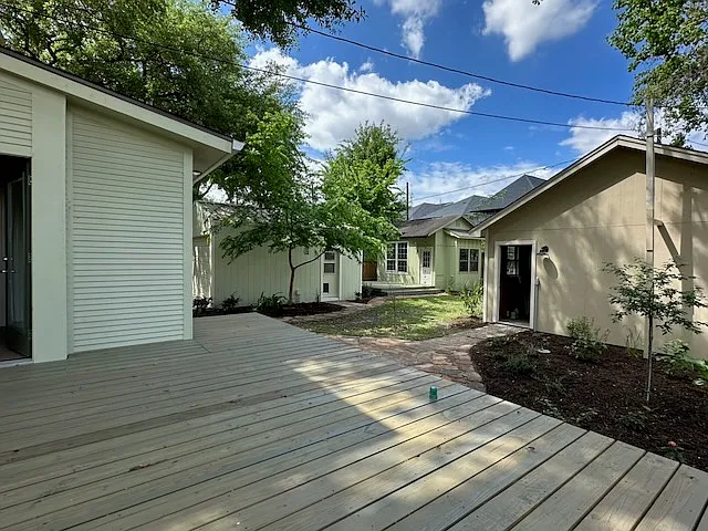 This view across the large deck shows the entry to the Mud Room, both Garages, and the Casita with its deck beyond. The Mud Room flows into the Kitchen and gives access to a full Bath and the Laundry Room.