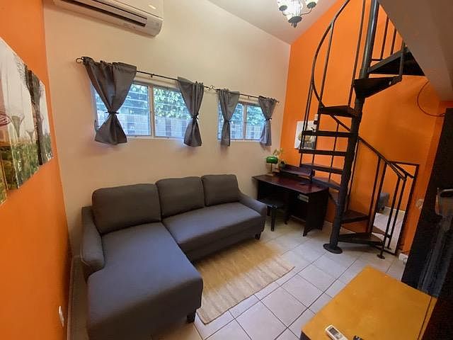 Air conditioned living room with couch that folds out to full size bed plus bed upstairs