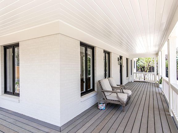 Wrap around patio in front of house.