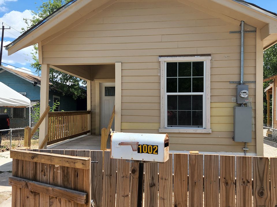 Front of house, parking on side, through open gate. Window is in second bedroom. Picture taken before metal roof installed.