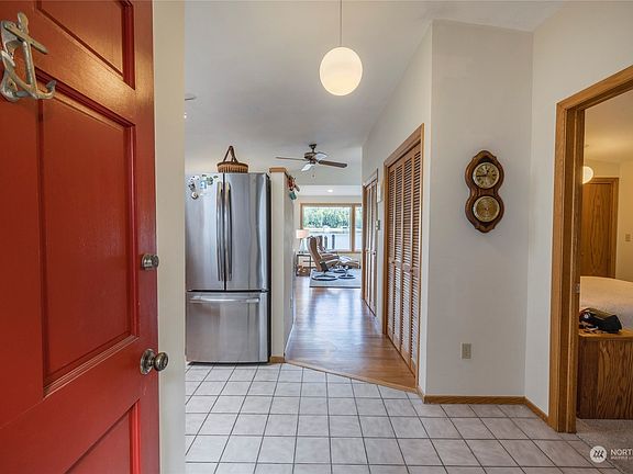 As you enter the home the bedroom and bathroom are directly on your right, living room straight ahead, dining room and kitchen on your left. Stacked washer and dryer behind the door in the kitchen. Tiled and hardwood floors throughout with carpeting in the bedroom.>