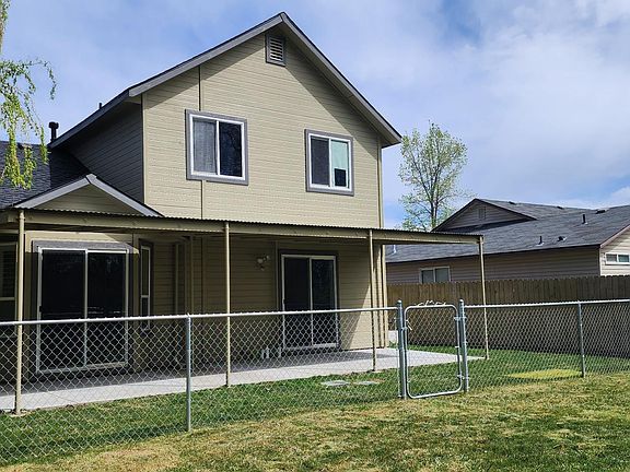 Fensed back yard with covered patio.