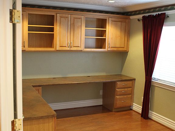 Office with two workstation spots and cabinets to match kitchen.