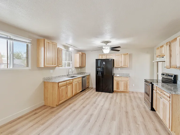 KITCHEN with REFRIGERATOR, RANGE, DISHWASHER & GARBAGE DISPOSAL. HICKORY CABINETS & GRANITE COUNTERTOPS.