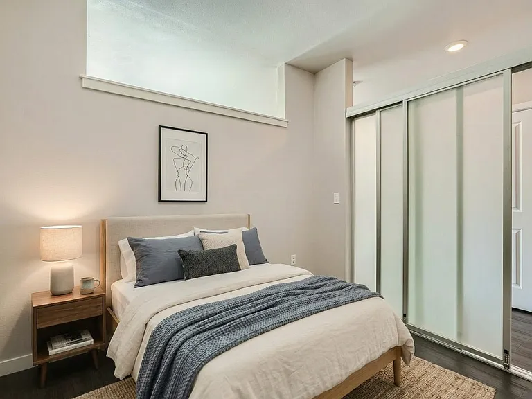 Unwind in a calm primary bedroom with closet storage built right in.