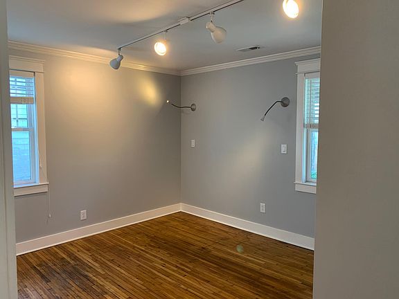 Spare bedroom with sidelights for easy bedtime reading and track light.