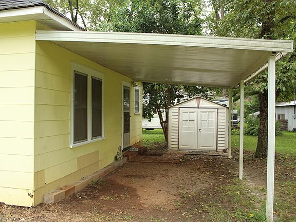 Back of the house showing carport and outbuilding.