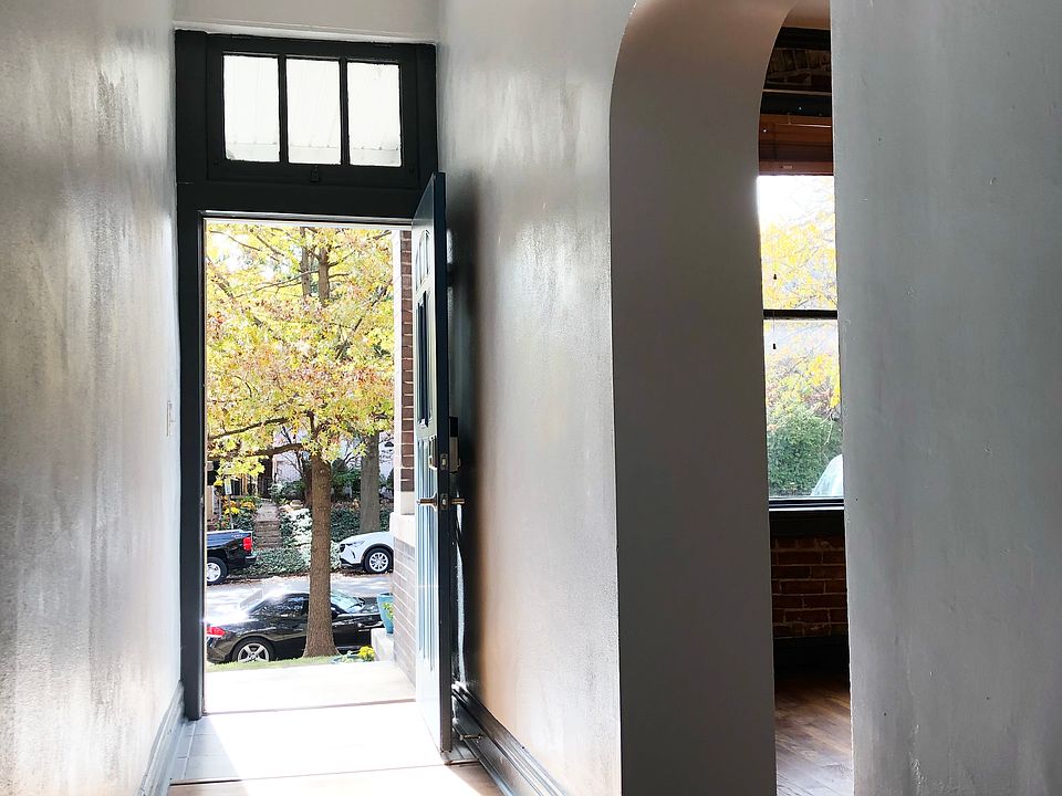 A transom over the front door brightens the hallway.