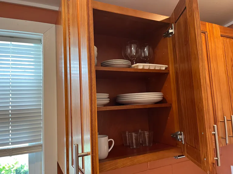 Fully furnished with dishes and cookware.