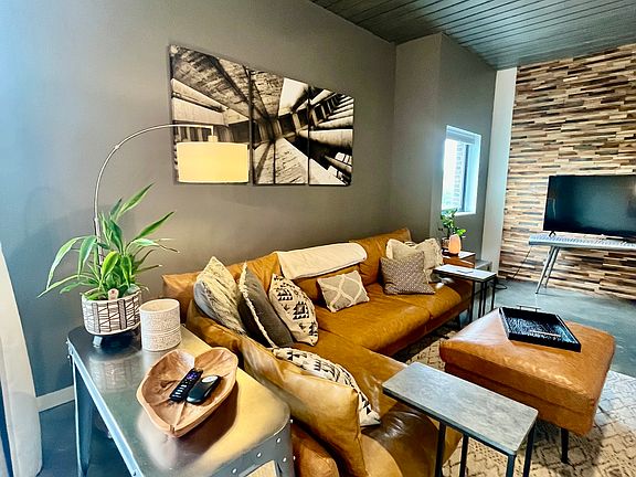 living room with vegan sectional and 60 in smart TV