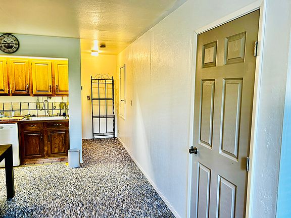 Door leading to stairs going to the garage and hallway leading to the bathroom and bedroom.