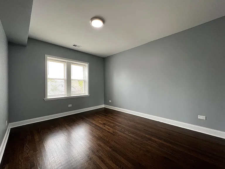 Primary bedroom with built-in organizer closet and mirrored doors. Large enough to easily accommodate a king-sized bed.