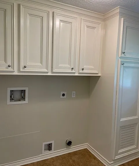Laundry room with substantial storage.