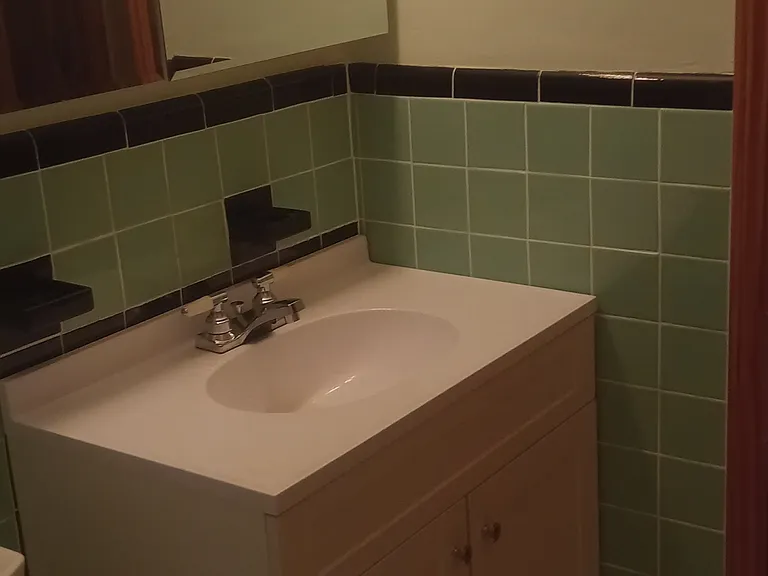 Bathroom view of new vanity and medicine cabinet from shower area