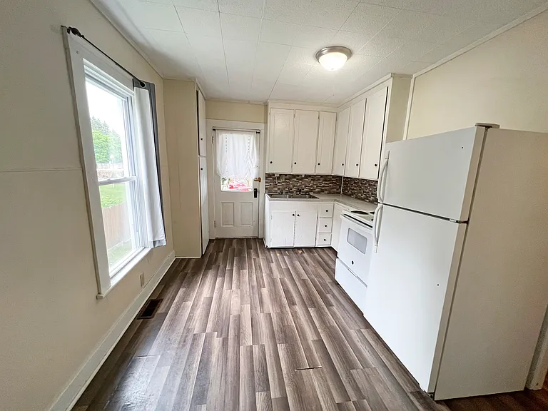 Bright and airy Kitchen with door leading to the Rear Deck