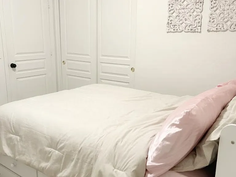 3rd bedroom with plush full-size bed, a pull-out trundle twin bed, closet, tall dresser, mounted smart tv.