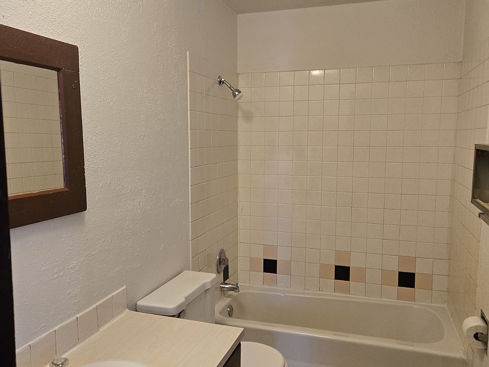 Freshly painted bathroom with unique tile flooring and bathroom surround.