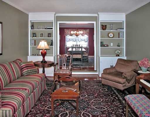 Step down into the spacious Living Room w/ new hardwood floors.