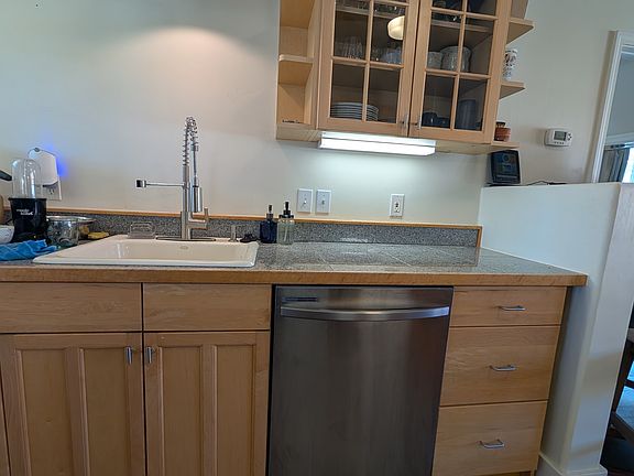 Fully stocked kitchen with all dishes, glasses and cookware.