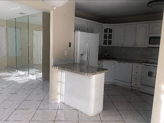 Diningroom area looking to kitchen and living room