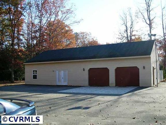 Oversized 2 car detached garage with workshop, electricity, heat and air.