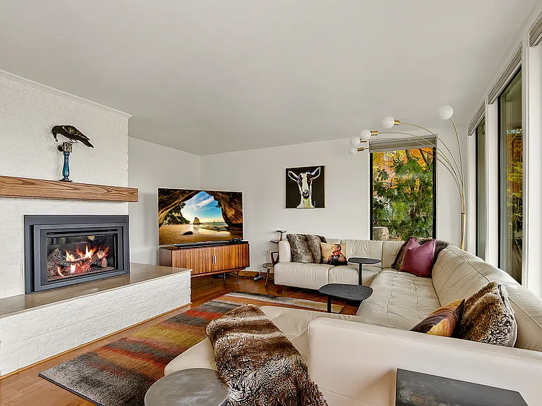 Second living room with gas fireplace and tv.