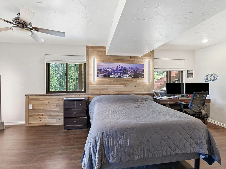 Your private retreat awaits! Oversized primary suite with dedicated workspace, custom accent wall, and direct access to the brand-new private deck overlooking the mountains
