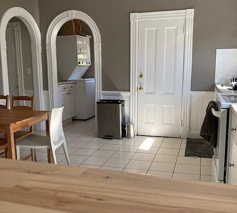 Arched kitchen doorways into laundry/ pantry, bathroom thru left