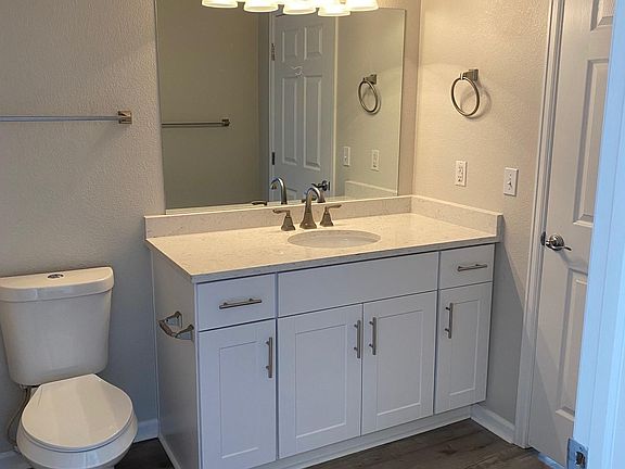 Bathroom w/ huge vanity & full tub.