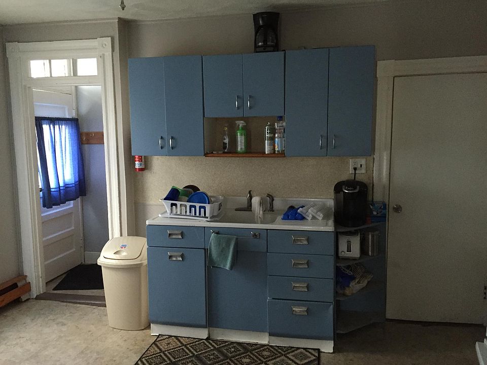Kitchen towards front door and basement door on right