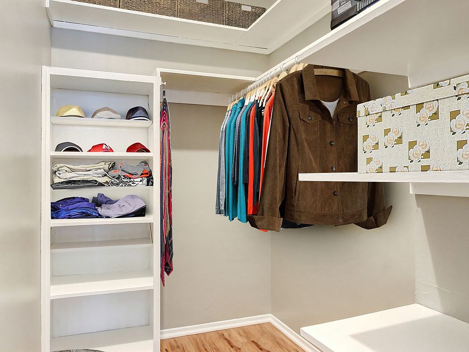 Spacious walk-in closet with wood-style floors
