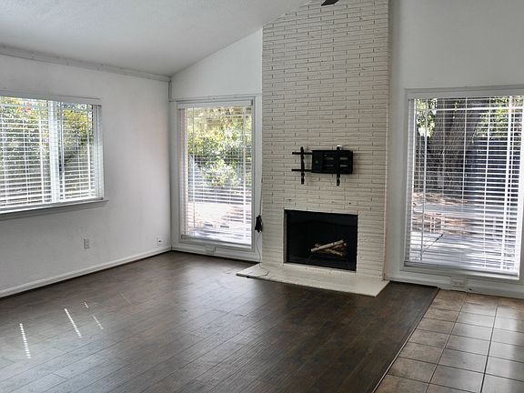 Great Room with Fireplace and Tall Windows and Exit to Rear Yard