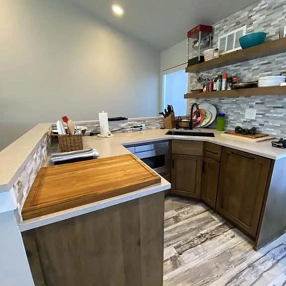 4th-floor kitchenette with Sub-Zero refrigerator and freezer drawers and Bosch dishwasher