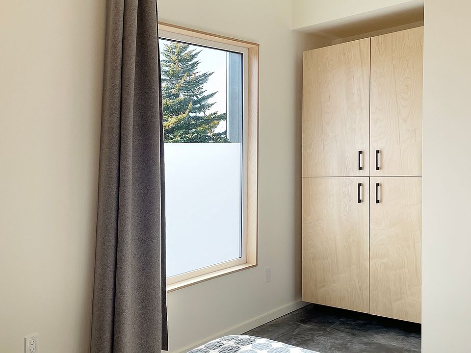bedroom has a built-in wardrobe closet and floor to ceiling wool curtain