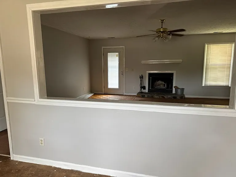 Standing from the dining room, looking thru cut out to see large living room. New floors to be installed 10 July.