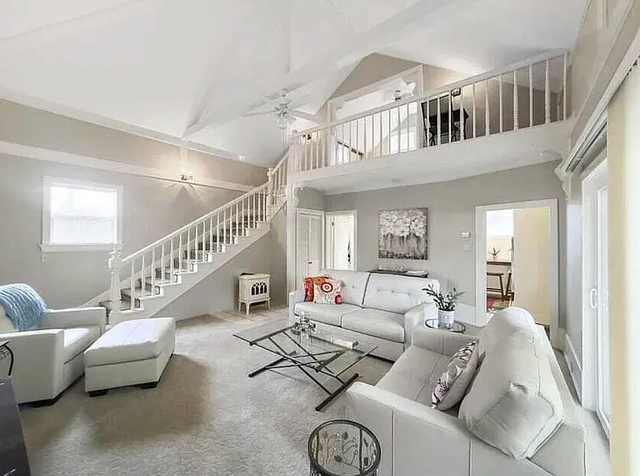 living room showing loft above