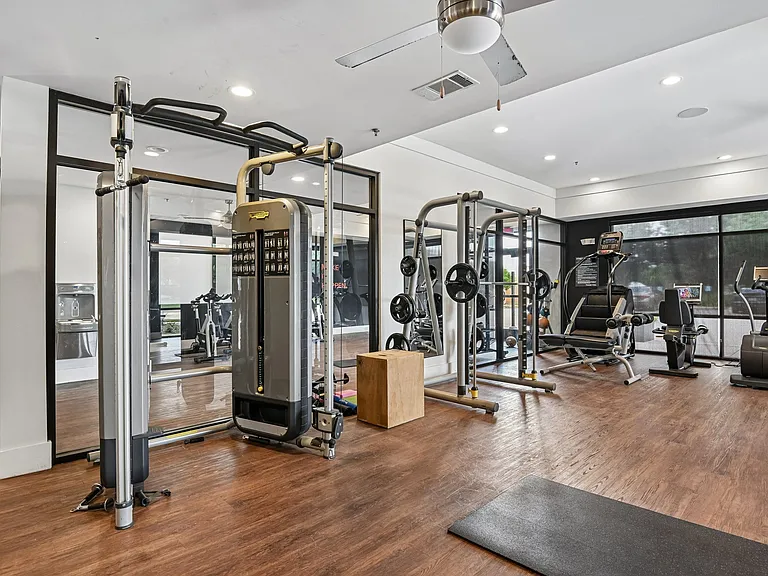 Markethaus 3700 A gym with a variety of equipment including a treadmill, weights, and a bench press.