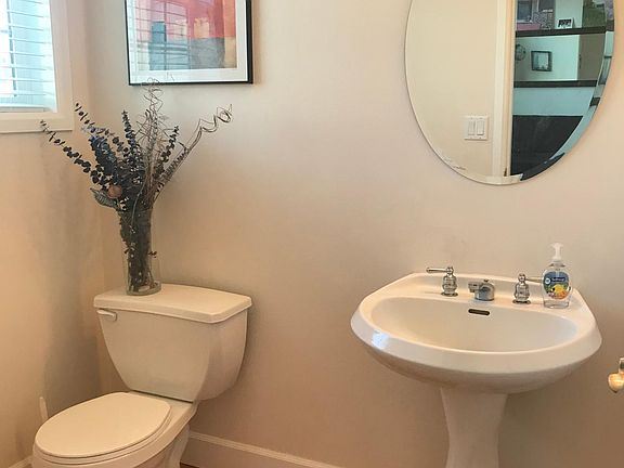 Powder room by entry off first level.