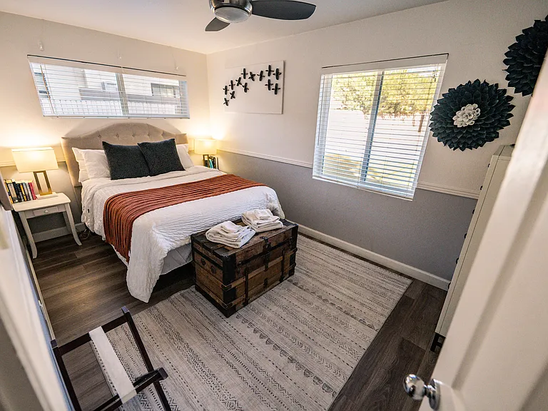 Bedroom 2 features a queen bed and large dresser