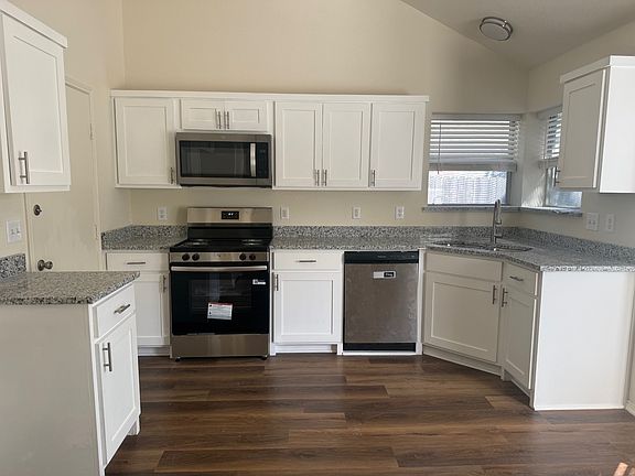 kitchen has new counter tops, cabinets, sink and oven